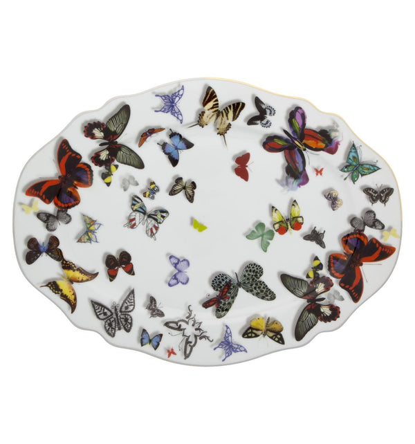 The Small Platter Butterfly Parade by Christian Lacroix features a parade of real and imaginary butterflies flying over the pieces, with notable three-dimensional effects. A half gold/half platinum rim makes it suitable for any decor.